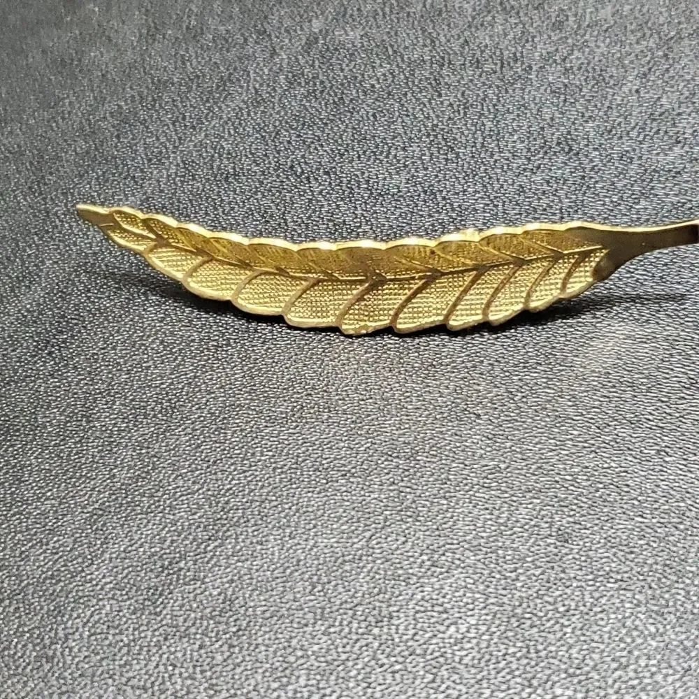 Gold tone leaf feather brooch